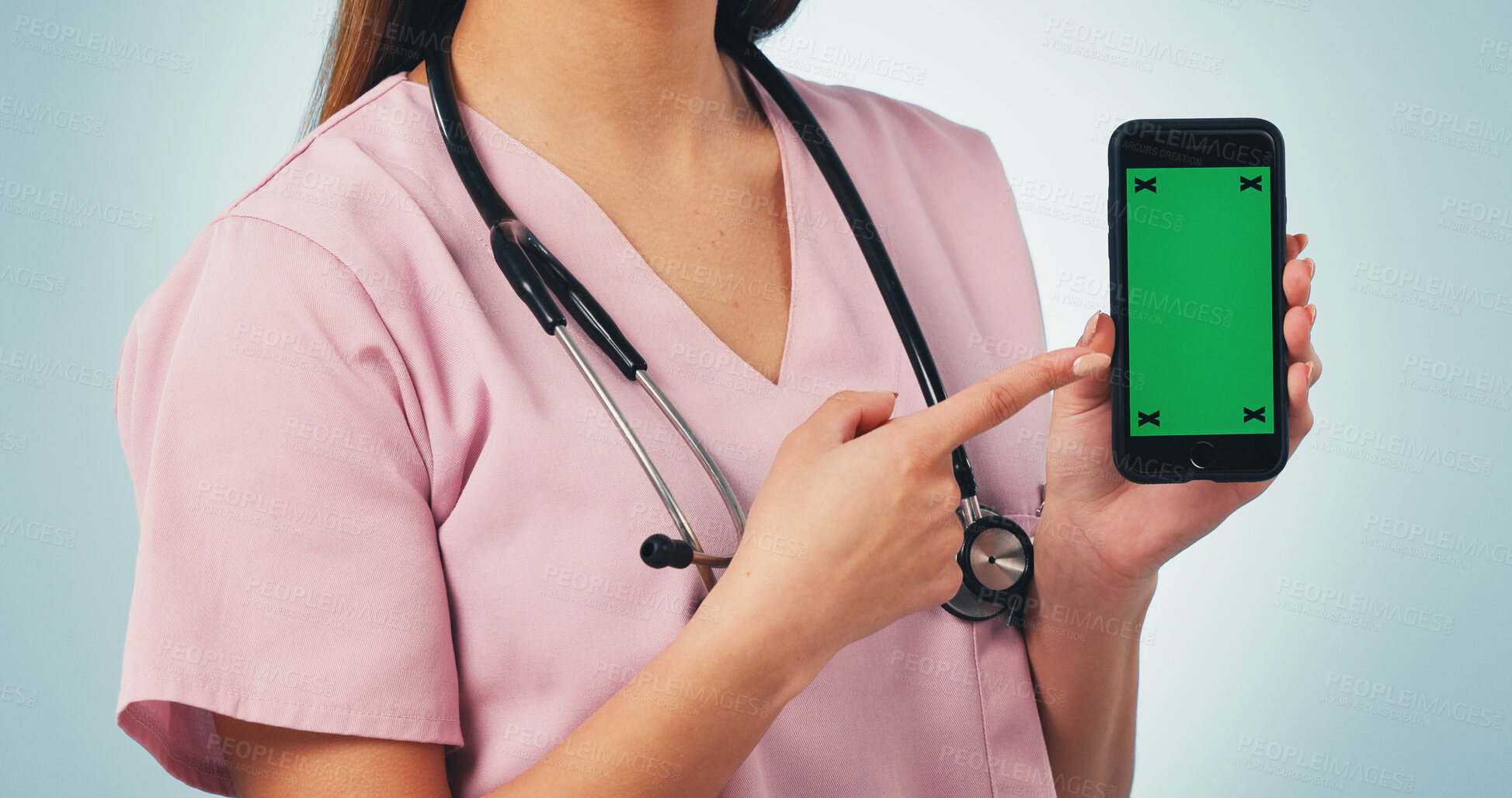 Buy stock photo Nurse, hands and pointing with phone green screen for advertising on a blue studio background. Female person, healthcare worker or showing smartphone display for UI, UX or Telehealth app on mockup
