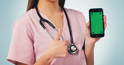 Buy stock photo Woman, hands and nurse with phone green screen, thumbs up or mockup on a blue studio background. Female person, healthcare worker or like emoji with smartphone display for Telehealth app or review