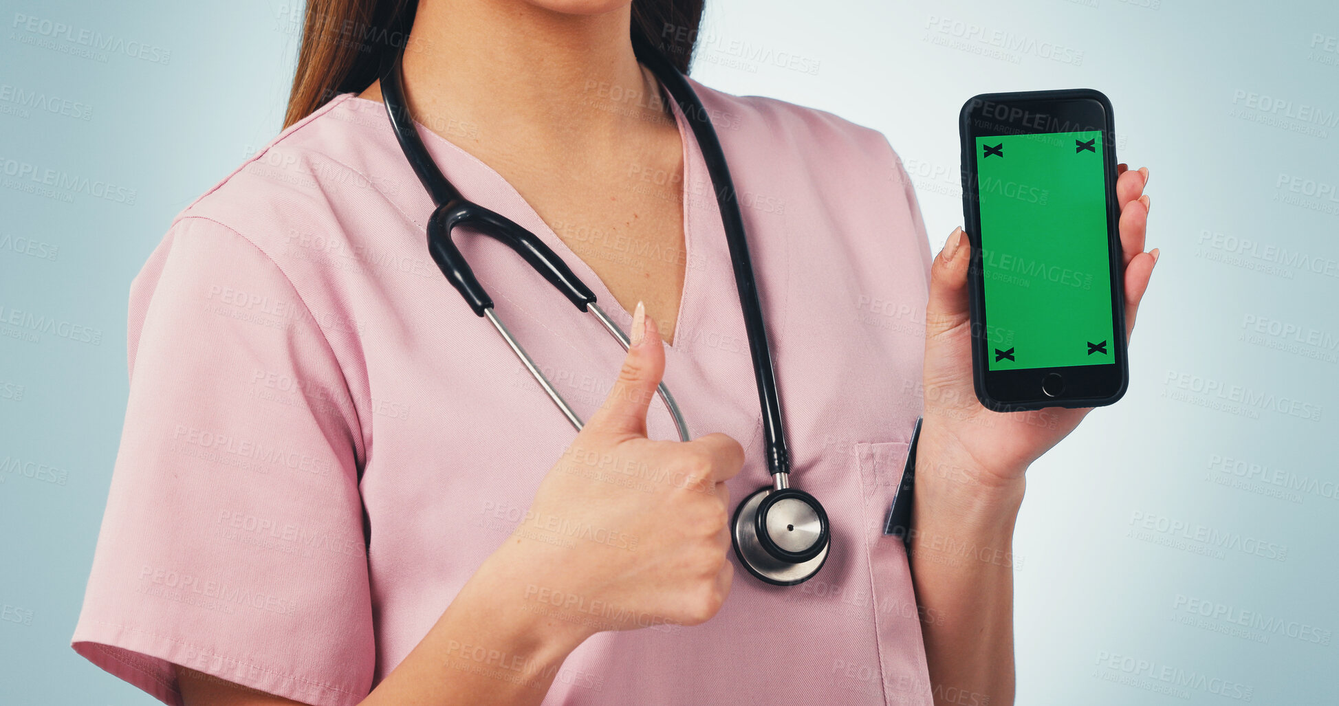 Buy stock photo Woman, hands and nurse with phone green screen, thumbs up or mockup on a blue studio background. Female person, healthcare worker or like emoji with smartphone display for Telehealth app or review
