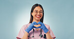 Portrait, nurse and woman in studio with heart hands, positive feedback and female reproductive health. Medical worker, person and happy with love sign, gynecology and gloves on blue background.
