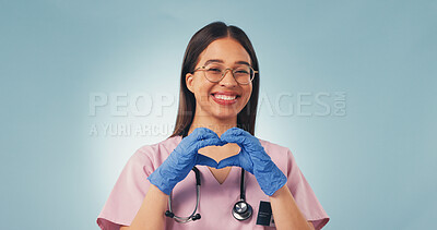 Buy stock photo Portrait, nurse and woman in studio with heart hands, positive feedback and female reproductive health. Medical worker, happy person or space with love sign, gynecology and gloves on blue background.