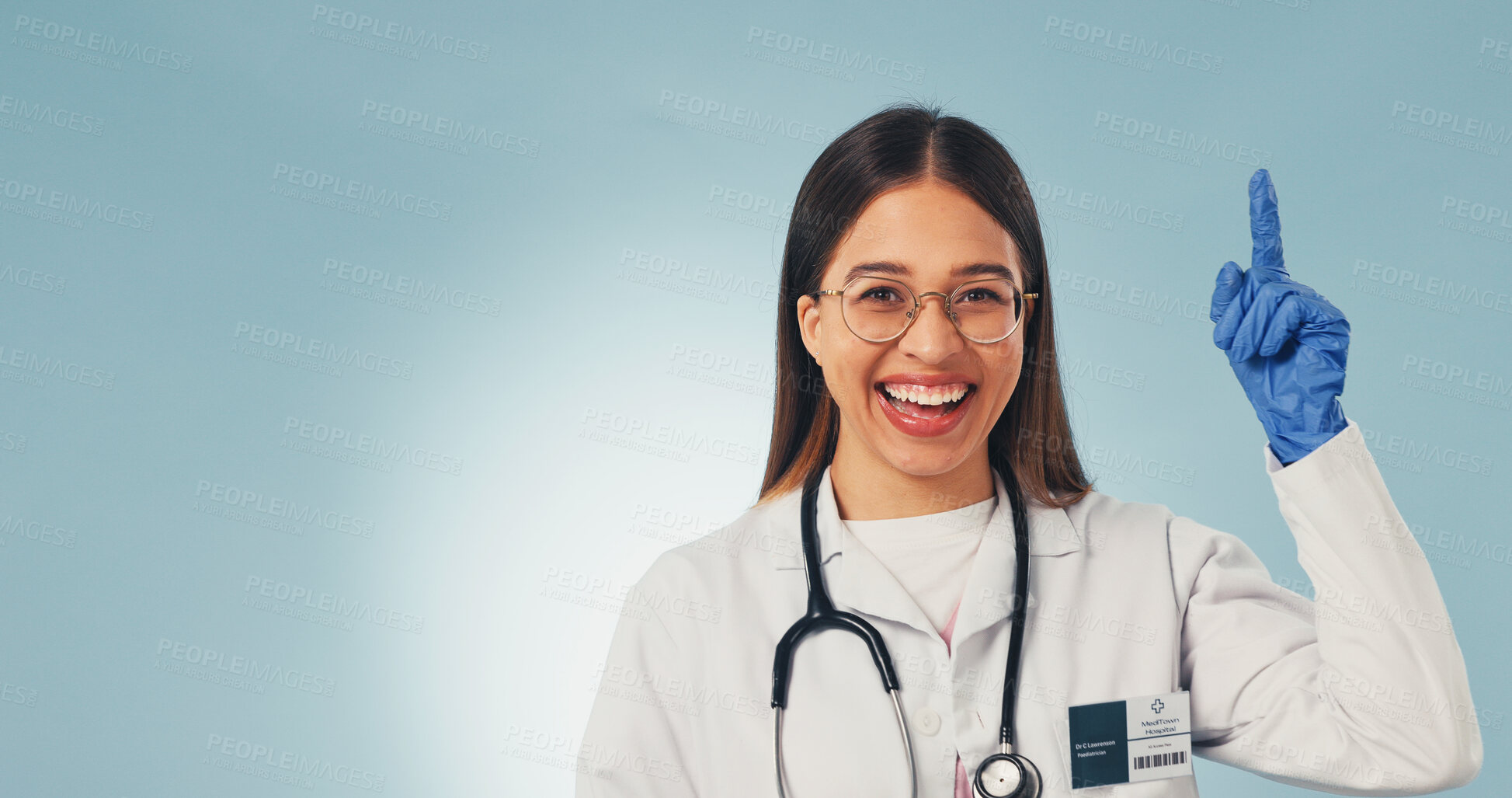 Buy stock photo Doctor, pointing and happy woman in studio, presentation and advice for healthcare service or point. Blue background, medical expert and person with portrait, space and laughing with health options
