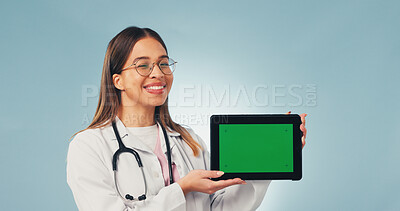 Buy stock photo Happy, tablet and portrait of doctor with green screen, mockup space or healthcare news. Smile, advertising and woman on tech for medical service, telehealth app or wellness info on studio background