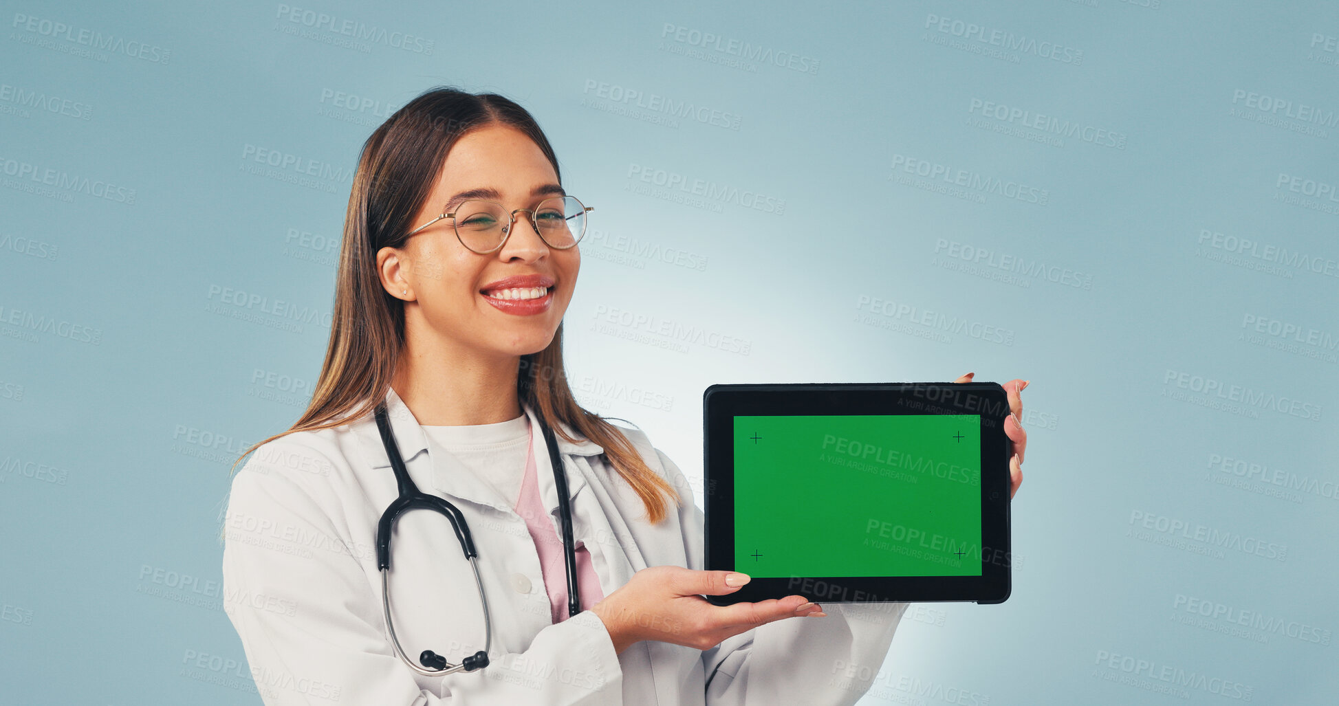 Buy stock photo Happy, tablet and portrait of doctor with green screen, mockup space or healthcare news. Smile, advertising and woman on tech for medical service, telehealth app or wellness info on studio background