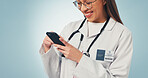 Happy, scrolling and doctor with phone in studio with telehealth, consultation or texting on app. Smile, woman and healthcare worker with cellphone for medical research on blue background by space.