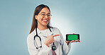 Portrait, phone and doctor pointing with green screen, mockup space or healthcare news. Happy, advertising and woman on cellphone for medical service, telehealth or mobile app ux on studio background