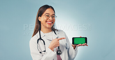 Buy stock photo Portrait, phone and doctor pointing with green screen, mockup space or healthcare news. Happy, advertising and woman on cellphone for medical service, telehealth or mobile app ux on studio background