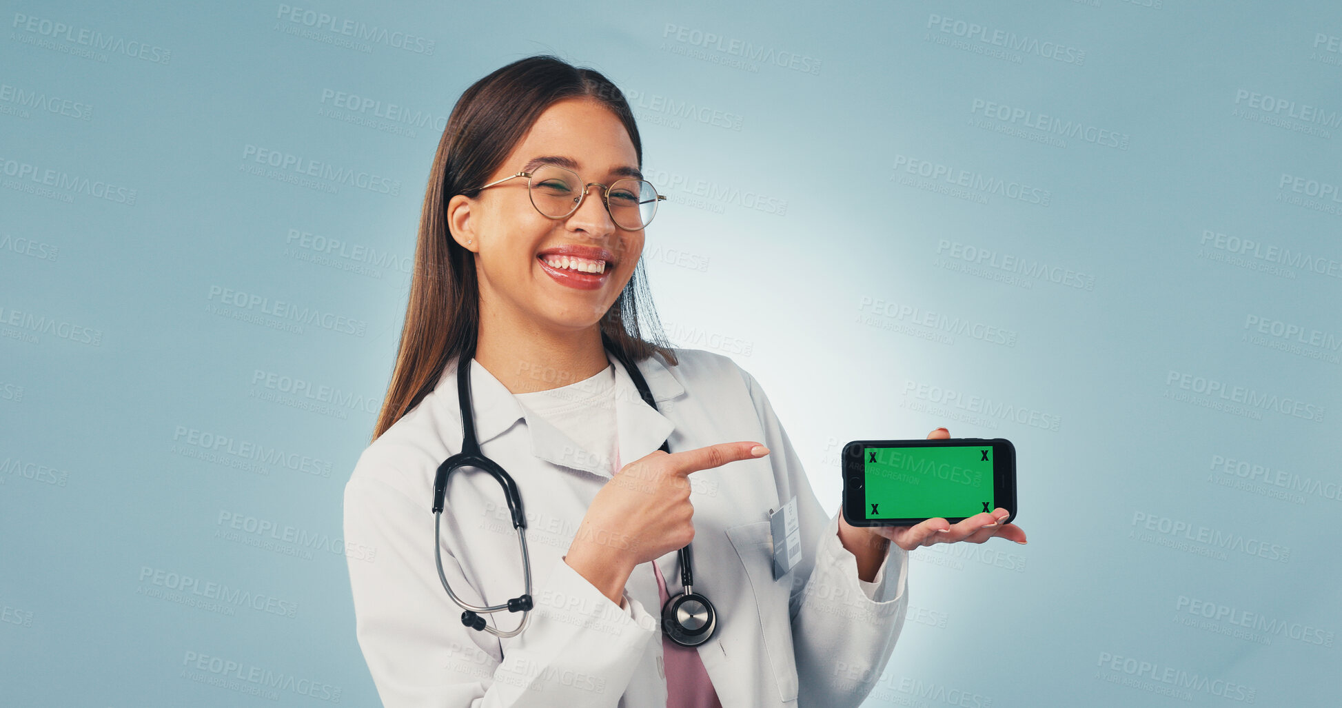 Buy stock photo Portrait, phone and doctor pointing with green screen, mockup space or healthcare news. Happy, advertising and woman on cellphone for medical service, telehealth or mobile app ux on studio background