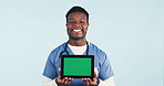 Green screen, nurse or man with tablet, medical advertising or telehealth on background. Happy black person, tech or healthcare worker with display for mockup space, marketing or portrait in studio