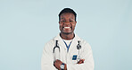 Medical, doctor and black man in studio with confidence, portrait and space on blue background. Happy person, arms crossed and healthcare worker with career integrity, about us and pride for wellness