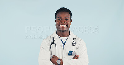 Buy stock photo Medical, doctor and black man in studio with confidence, portrait and space on blue background. Happy person, arms crossed and healthcare worker with career integrity, about us and pride for wellness
