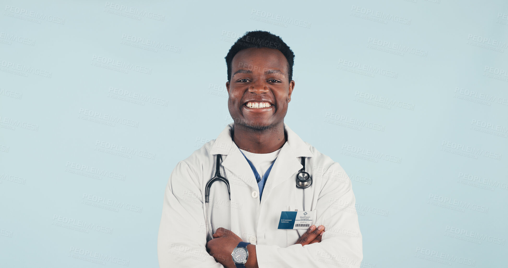 Buy stock photo Medical, doctor and black man in studio with confidence, portrait and space on blue background. Happy person, arms crossed and healthcare worker with career integrity, about us and pride for wellness