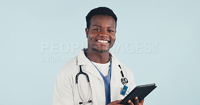 Buy stock photo Medical, doctor and black man in studio with tablet, portrait and space on blue background. Happy person, technology and healthcare worker with career integrity, about us and pride for wellness