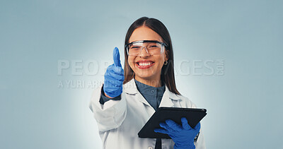 Buy stock photo Portrait, scientist and thumbs up in studio with tablet, achievement or success for medical innovation. Space, happy woman and like sign with tech, science research approval or PPE on blue background