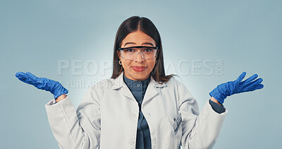 Buy stock photo Portrait, scientist and woman in studio with shrug, goggles and confused for medical research options. PPE, person and decision with healthcare science, uncertainty and question on blue background.