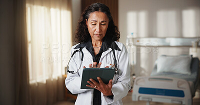 Buy stock photo Doctor, woman and tablet in hospital with internet for schedule, planning or medical research. Mature person, technology and serious on telehealth app for healthcare, information or advice on website