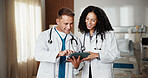 Pointing, smile and tablet with doctors in hospital together for advice, discussion or feedback. App, collaboration and healthcare with happy medical people in clinic for help, support or wellness