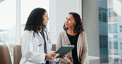 Buy stock photo Clinic, patient and doctor with tablet, healthcare and explaining medical diagnosis or consultation. Hospital, health professional and happy women with technology, checkup and test results on website