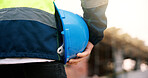 Construction, helmet or hand on site with safety, protection gear or equipment in building project. Man, back or hardhat for risk control, ppe compliance or hazard prevention in industrial industry.
