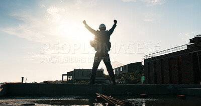 Buy stock photo Man, architect or celebration with fist pump on building for foundation finish on construction site. Back view, male person or civil engineer with lens flare for architecture success or done project