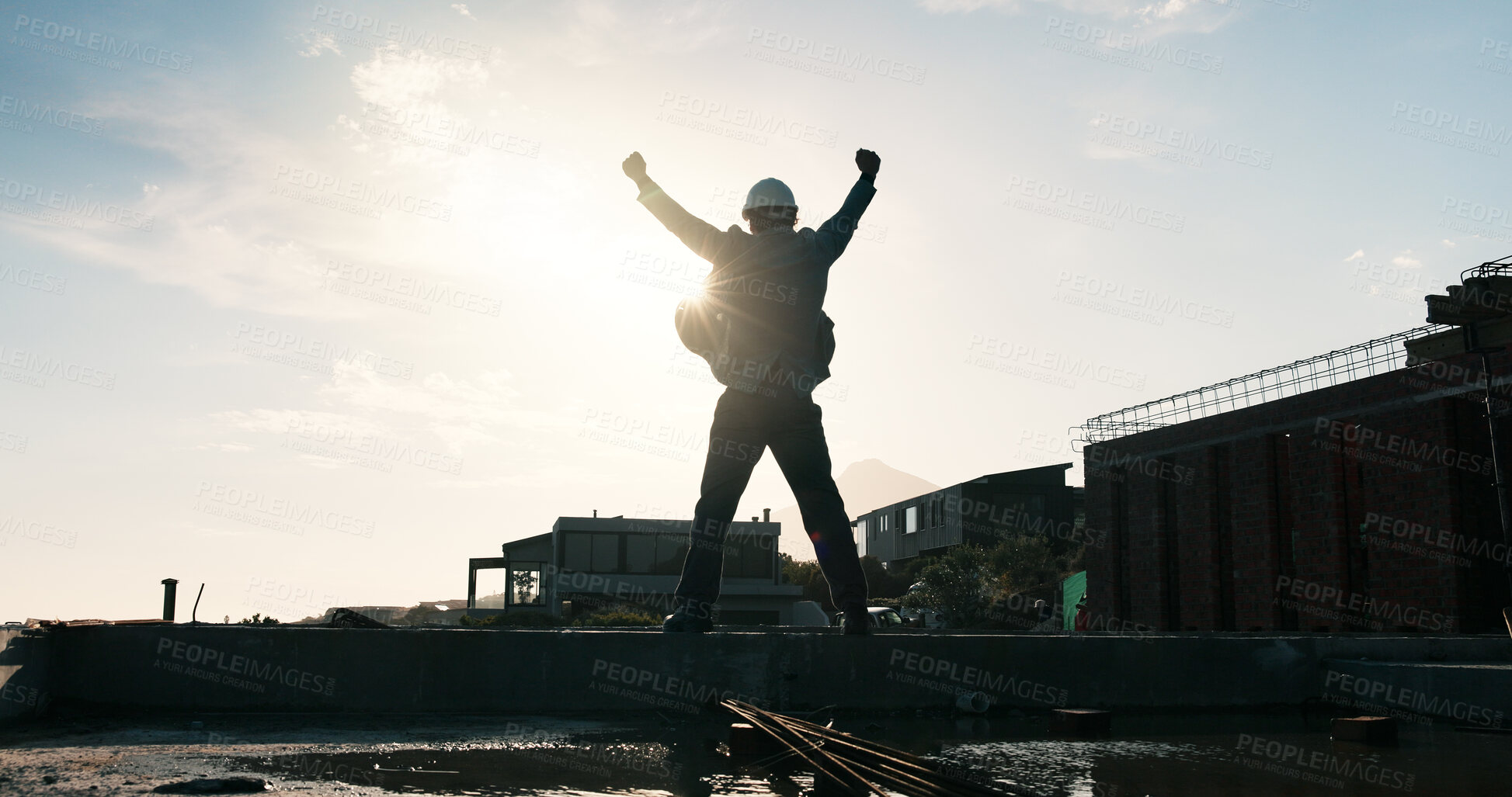 Buy stock photo Man, architect or celebration with fist pump on building for foundation finish on construction site. Back view, male person or civil engineer with lens flare for architecture success or done project