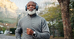 Fitness, headphones and running with black man outdoor for cardio training or workout routine. Exercise, happy and music with mature runner in neighborhood for challenge, development or streaming