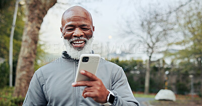 Buy stock photo Outdoor, earphones and man with phone, fitness and watching funny exercise tutorial on social media. Mature runner, laughing and black person with mobile on workout break, online and streaming music