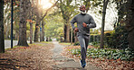 Serious, man and running on road, fitness and endurance for physical activity or cardio for wellness. Outdoor, mature runner and black person on street, training and workout routine to lose weight