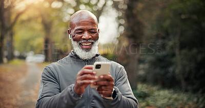 Buy stock photo Outdoor, earphones and man with phone, exercise and watching funny fitness tutorial on social media. Mature runner, laughing and black person with mobile on workout break, online and streaming music