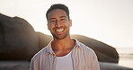 Portrait, happy and man on beach for travel, sunshine and seaside holiday with positive attitude outdoor. Person, traveller and space in nature with smile, good mood and weekend break by the ocean