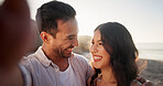 Selfie, couple and happy on beach for love, travel and seaside holiday with photo for memory. Man, woman and smile for healthy relationship, coastal vacation and capture picture outdoor with bonding