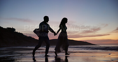 Buy stock photo Couple, walking and holding hands at beach with smile, travel and romantic date on holiday. Sunset, people and journey on seashore with space, commitment and tropical vacation for adventure getaway
