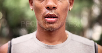 Buy stock photo Fitness, break and mouth in park with sweat, cardio exhaustion and cool down in outdoor practice. Fatigue, bokeh and man in nature with breathing, training pause and exercise burnout with recovery.