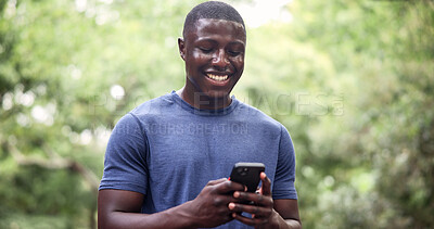 Buy stock photo Fitness, athlete and man with phone at park, online and texting with smile on social media and chat. Happy, runner and black person with mobile for workout update, sweating and communication on break