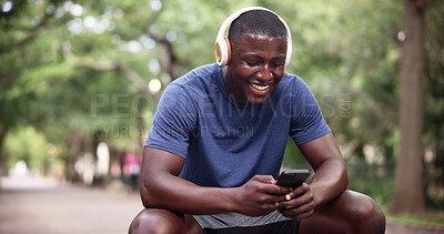 Buy stock photo Fitness, headphones and man with phone on break, laughing and texting with smile on social media app. Happy, athlete and black person with mobile for workout update, sweating and listening to music