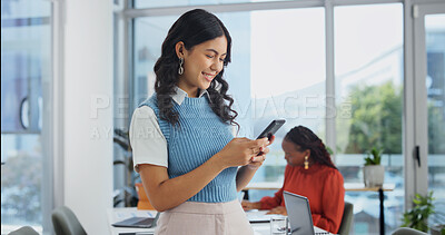 Buy stock photo Phone, smile and woman in office meeting, text or reading notification for venue budget approval. Mobile, event planner and happy person with business email, vendor coordination or project progress