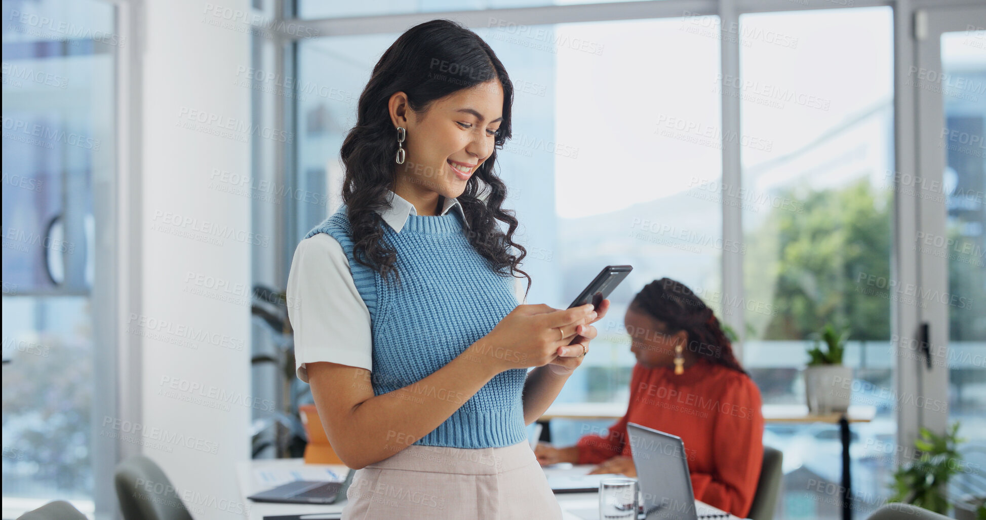 Buy stock photo Phone, smile and woman in office meeting, text or reading notification for venue budget approval. Mobile, event planner and happy person with business email, vendor coordination or project progress
