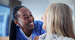Laugh, nurse and old woman in home with support, medical care and talk for help in assisted living. Retirement, caregiver and happy person with comfort, trust and healthcare with joke in homecare