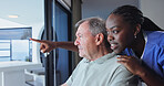 Nurse, old man and happy with pointing for senior care, wellness and view with smile in home. Caregiver, person with disability and talking for assistance, helping hand and support for homecare