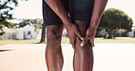 Legs, knee pain and person with injury on basketball court for exercise, fitness or training accident. Hands, sports athlete and massage muscle for fibromyalgia, arthritis or health crisis outdoor