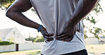Hands, person and back pain with accident on basketball court for exercise, fitness or training injury. Park, sports athlete and massage muscle for fibromyalgia, arthritis or health crisis outdoor