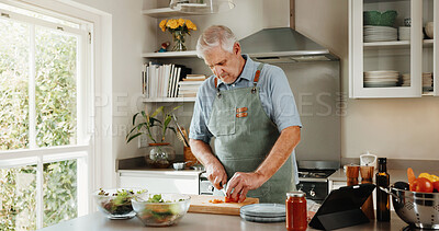 Buy stock photo Senior, man and cooking in kitchen with vegetables, tablet and healthy food for retirement wellness. Elderly person, meal prep and chop in home with ingredients, nutrition and tech for lunch recipe.