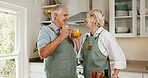 Senior, couple and cooking in kitchen with orange juice, funny joke and healthy diet for retirement. Happy, married old man and woman in home with drink, meal preparation and humor for connection.