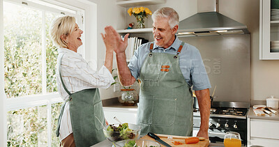 Buy stock photo Senior, couple and cooking in kitchen with high five, bonding together and laugh for funny joke. Happy, married elderly people and celebration in house for meal prep, humor and healthy nutrition.