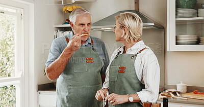 Buy stock photo Cooking, tasting and old couple in kitchen with help, connection and bonding with meal prep. Retirement, food sampling and elderly people with spoon, healthy relationship or culinary hobby in home.