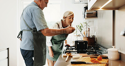 Buy stock photo Cooking, food and old couple in kitchen with taste, connection and bonding with meal prep. Retirement, sampling and elderly people with spoon, healthy relationship and culinary hobby in home.