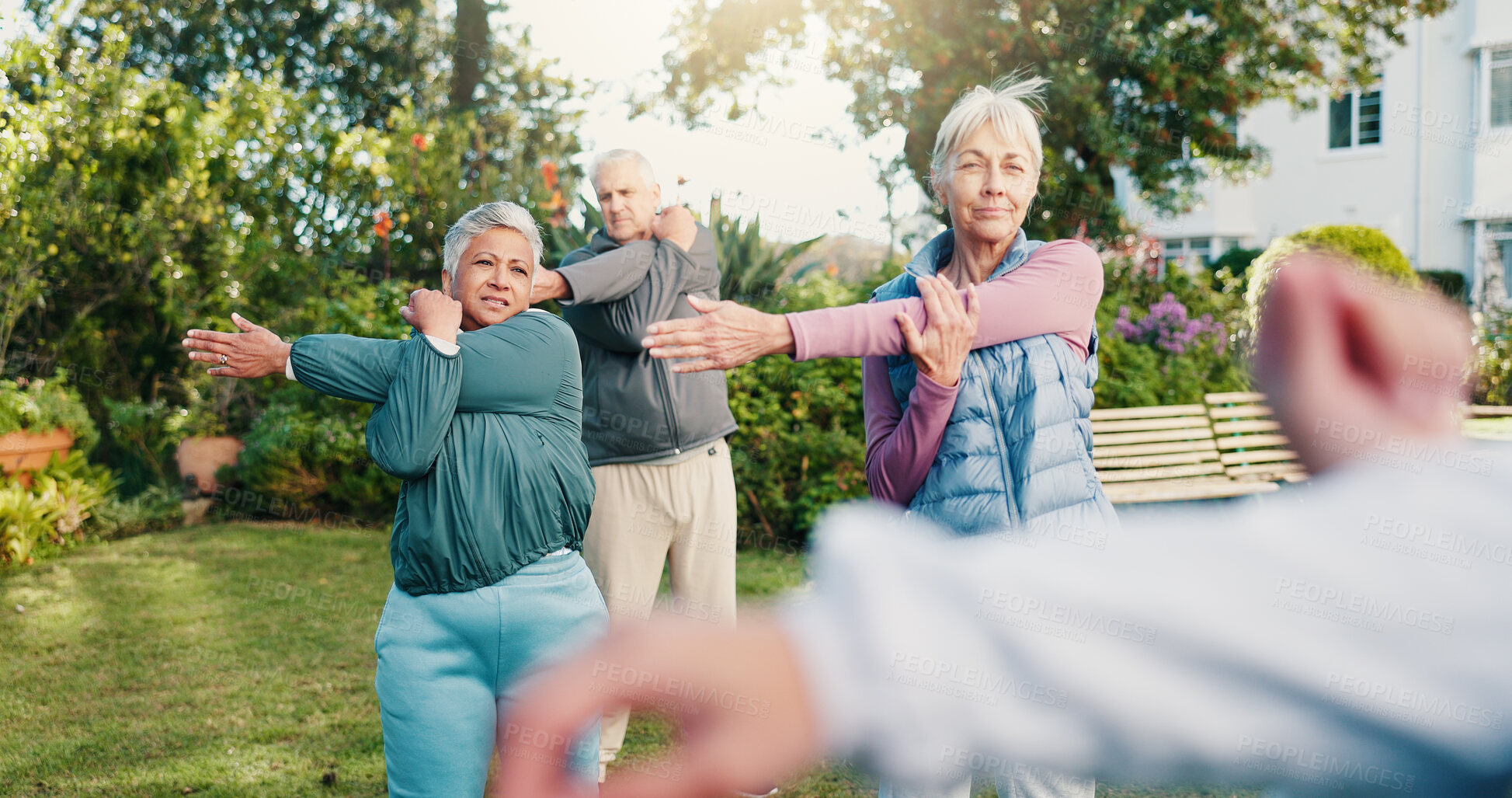 Buy stock photo Stretching, class and old people outdoor with personal trainer, guidance and mobility for wellness. Active, senior group and warm up in retirement home garden with fitness coach, workout or movement.