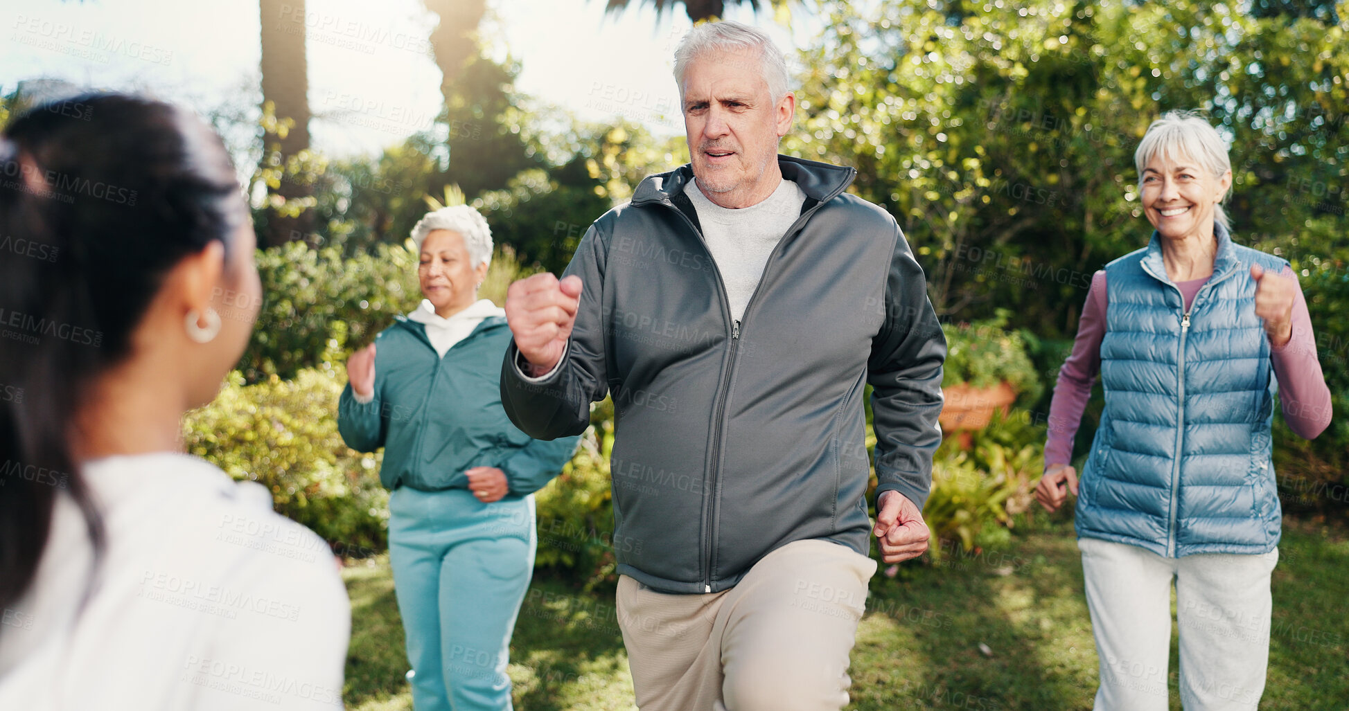Buy stock photo Exercise, man and old people outdoor with personal trainer, movement together and smile for wellness. Fitness coach, senior group and happy in garden with cardio workout, guidance or retirement club.