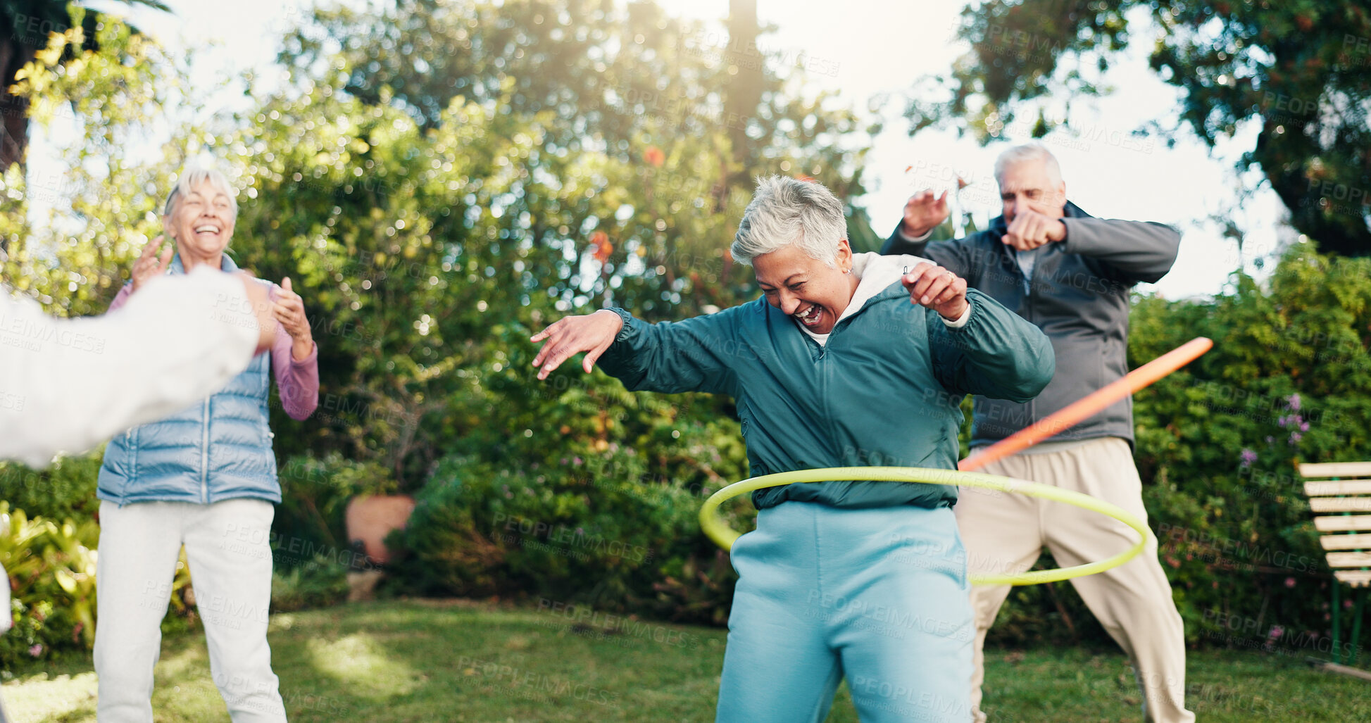 Buy stock photo Smile, elderly people and hoop in park for fitness, body mobility and outdoor for wellness. Happy, senior group and plastic ring toy for core training, warm up exercise or retirement health in nature