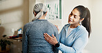 Physio, checkup and woman in office with back pain, assessment and recovery from injury. Physiotherapist, massage and mature person at clinic for physiotherapy, spine evaluation and rehabilitation